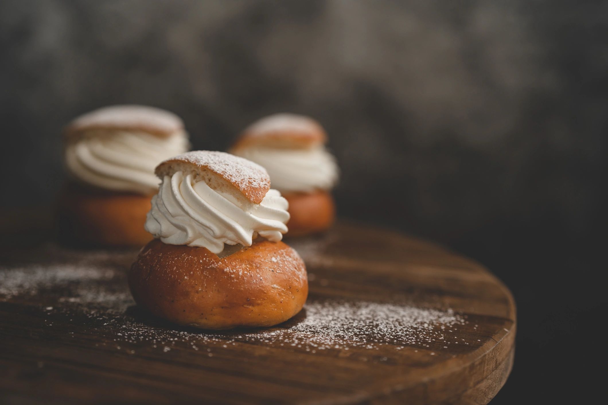 Semla pastry with whipped cream and powdered sugar