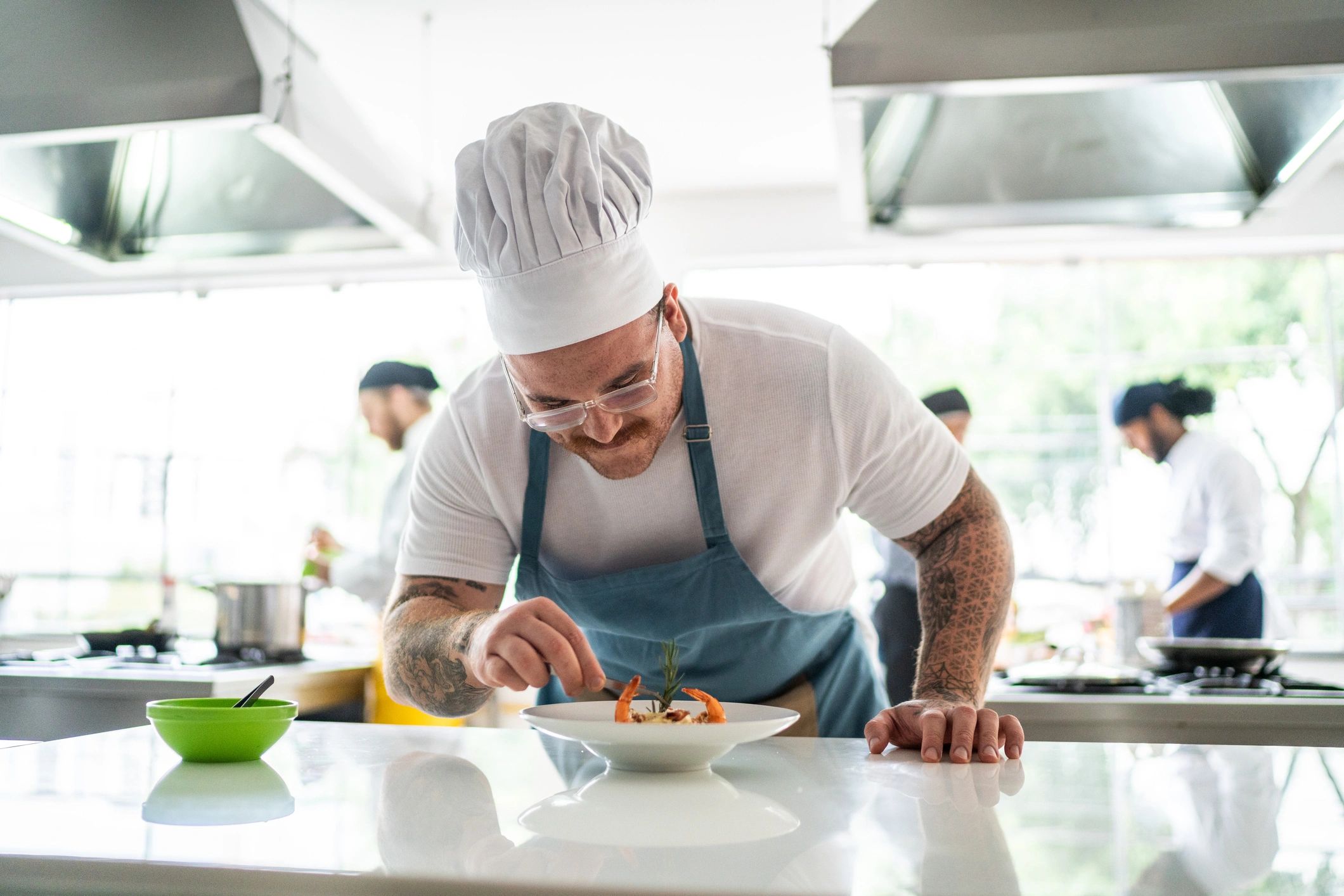 Chef arranging details on a pasta dish
