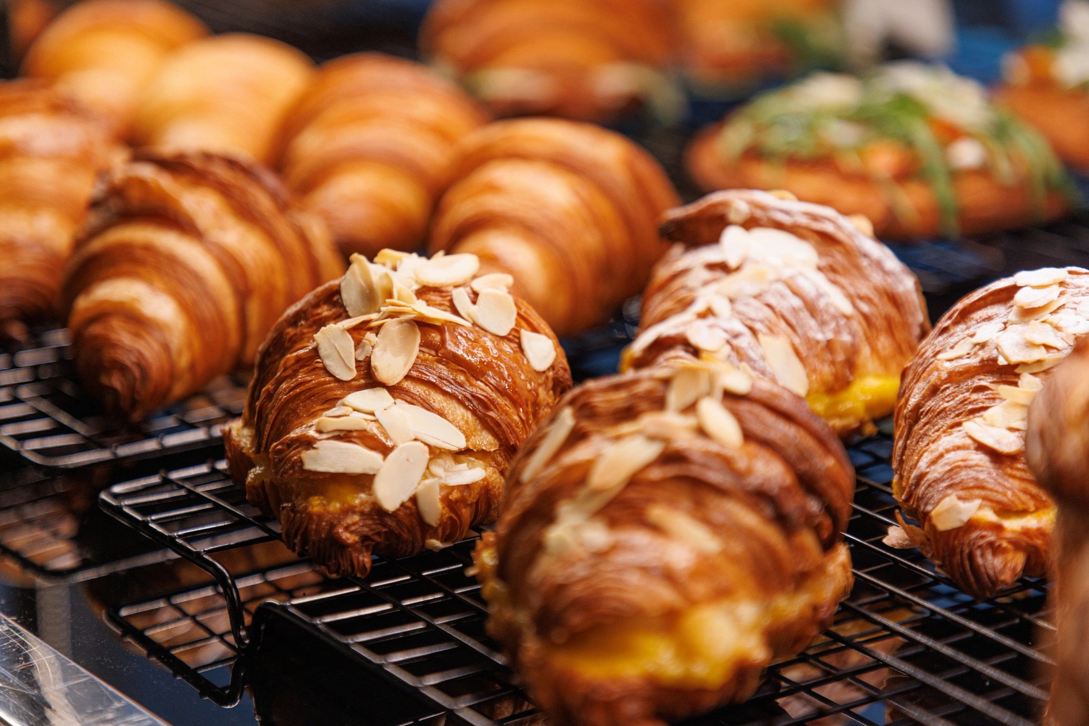 Croissants on a rack with cream and chocolate topping