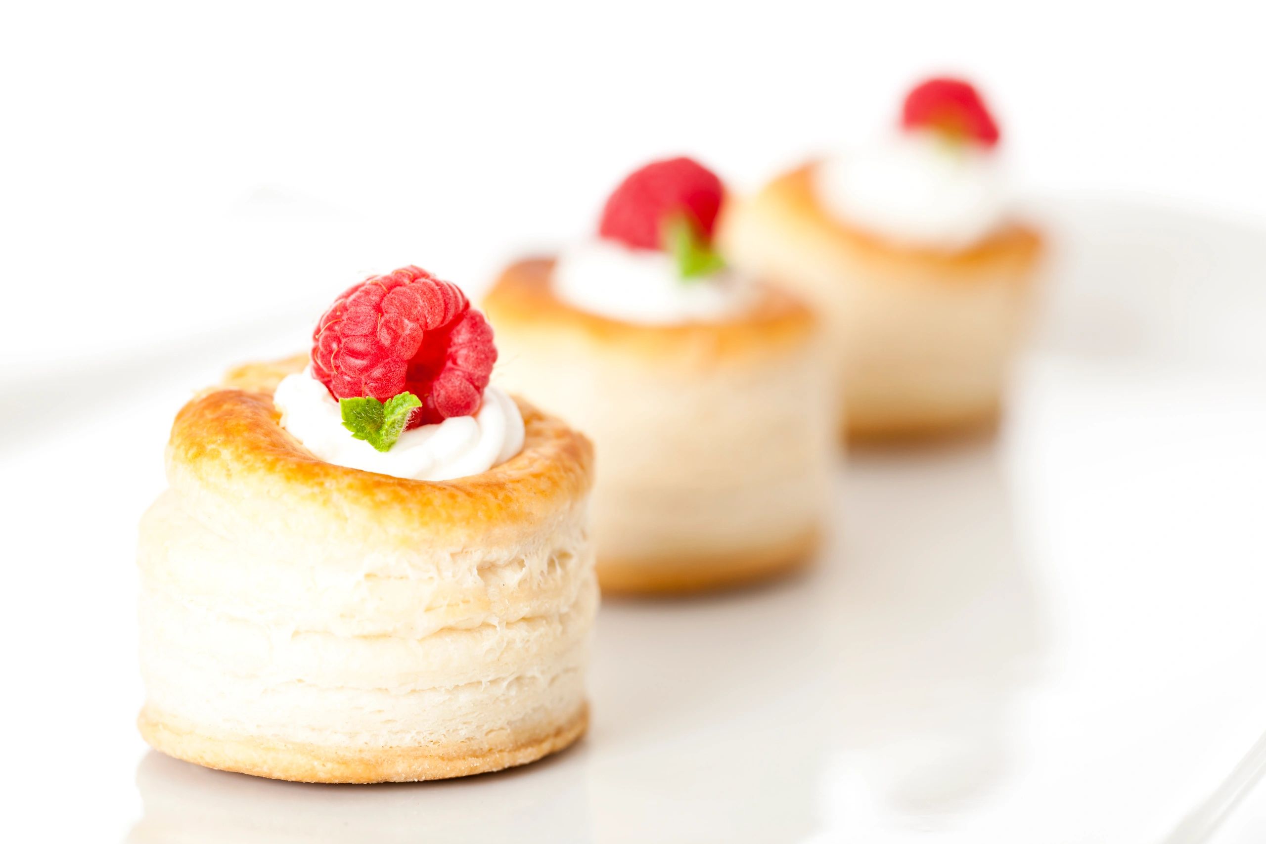 Fresh raspberry tarts on a tray