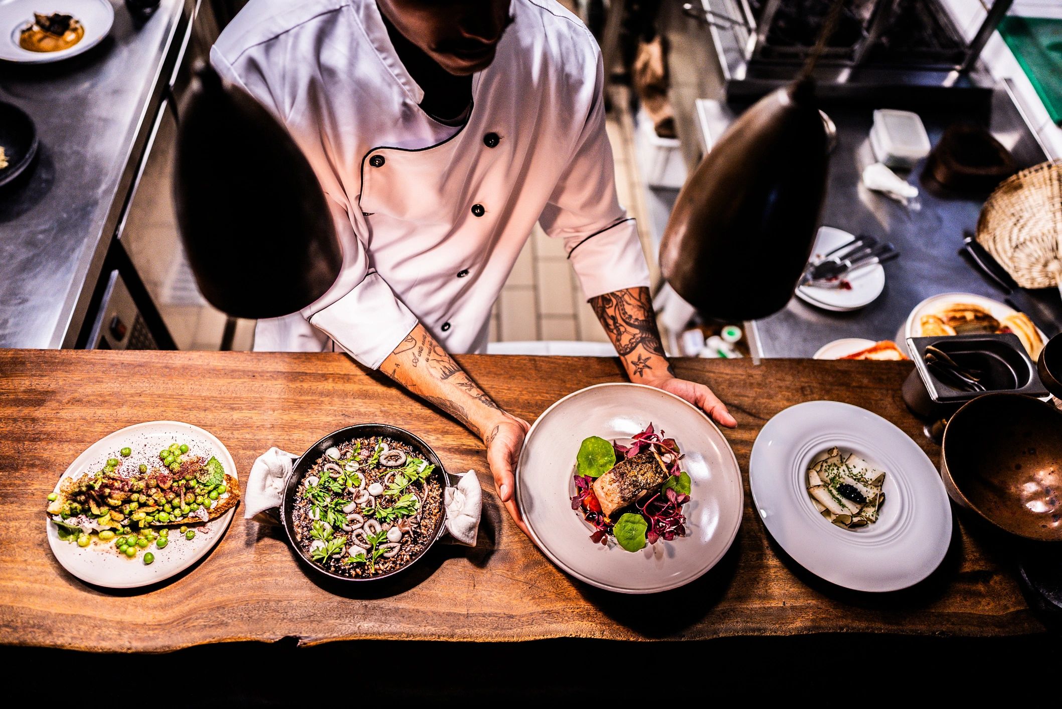 Chef plating a dish in a restaurant kitchen