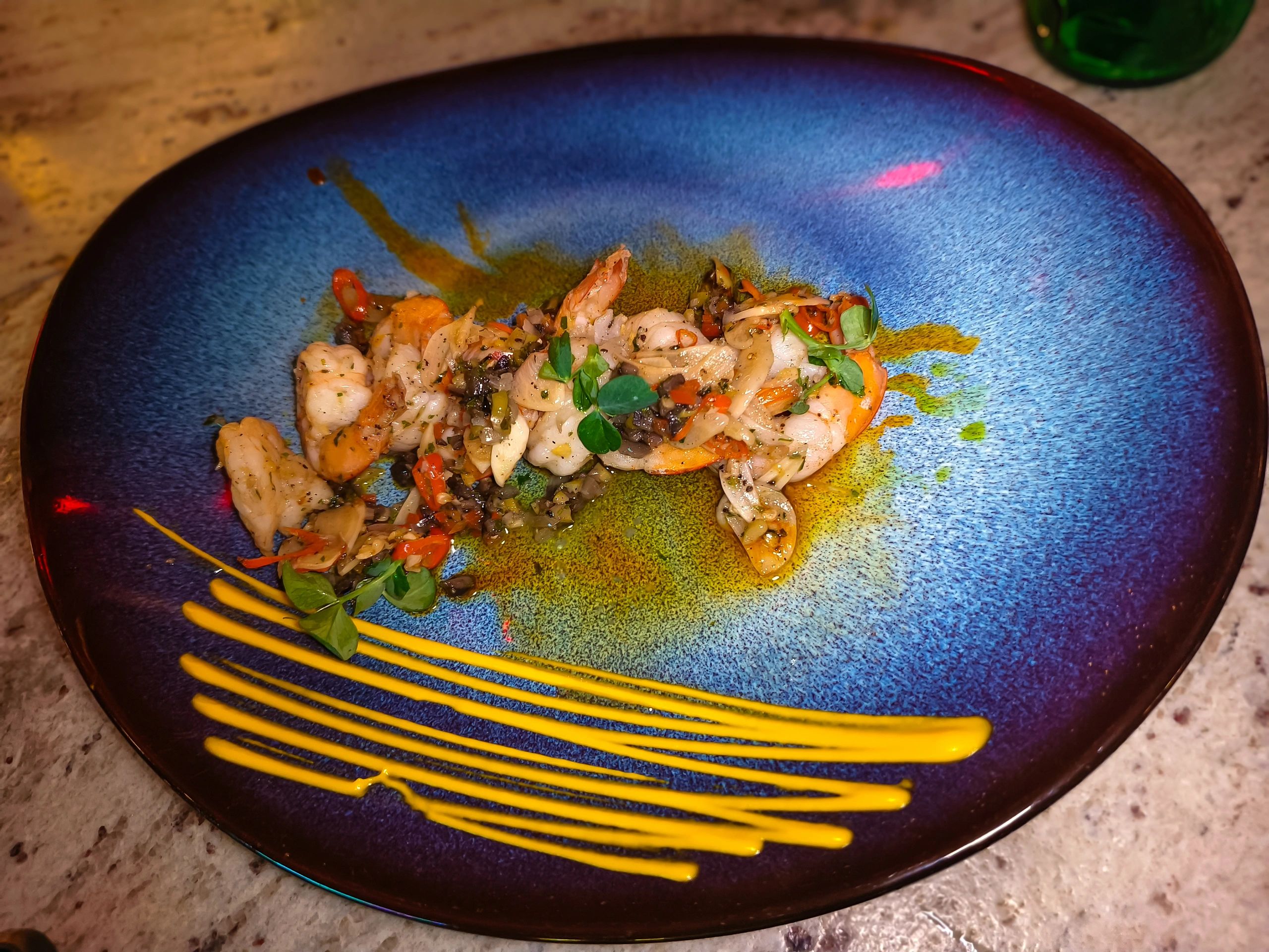 Prawn masala plated with microgreens