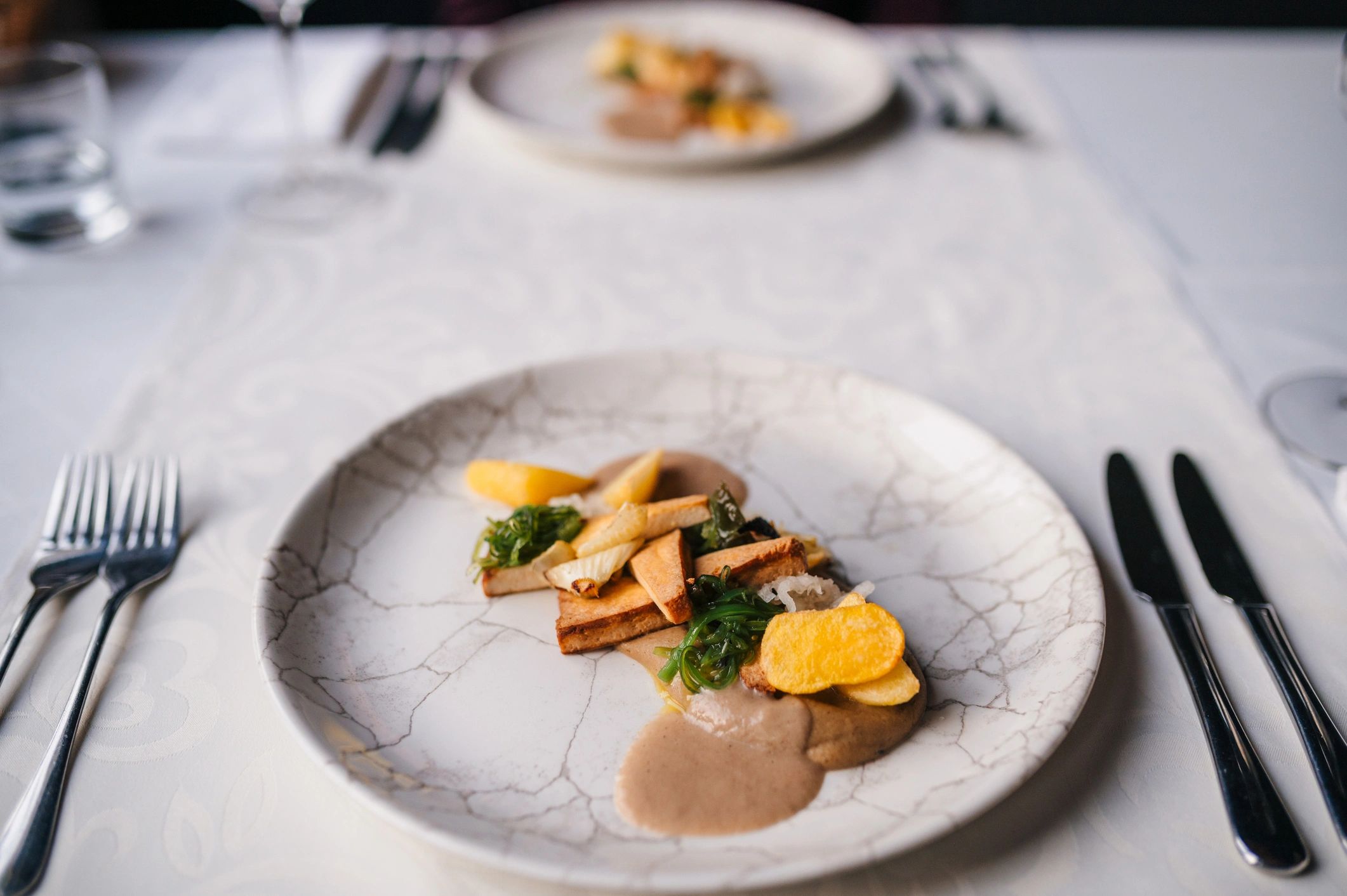 Elegant plated vegetarian dish with pumpkin sauce