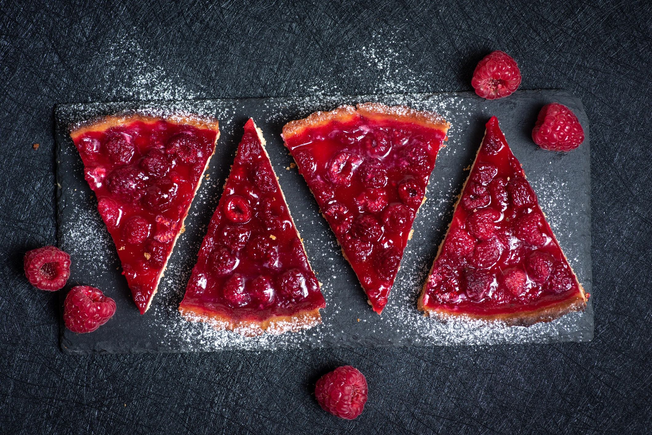 Raspberry tart slices photographed from above