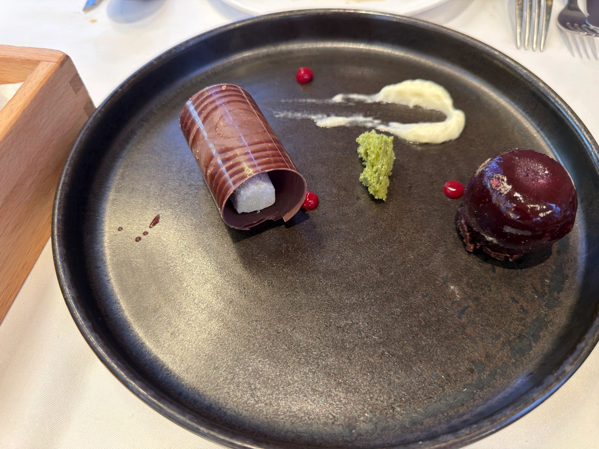 Modern plated dessert with chocolate and fruit elements