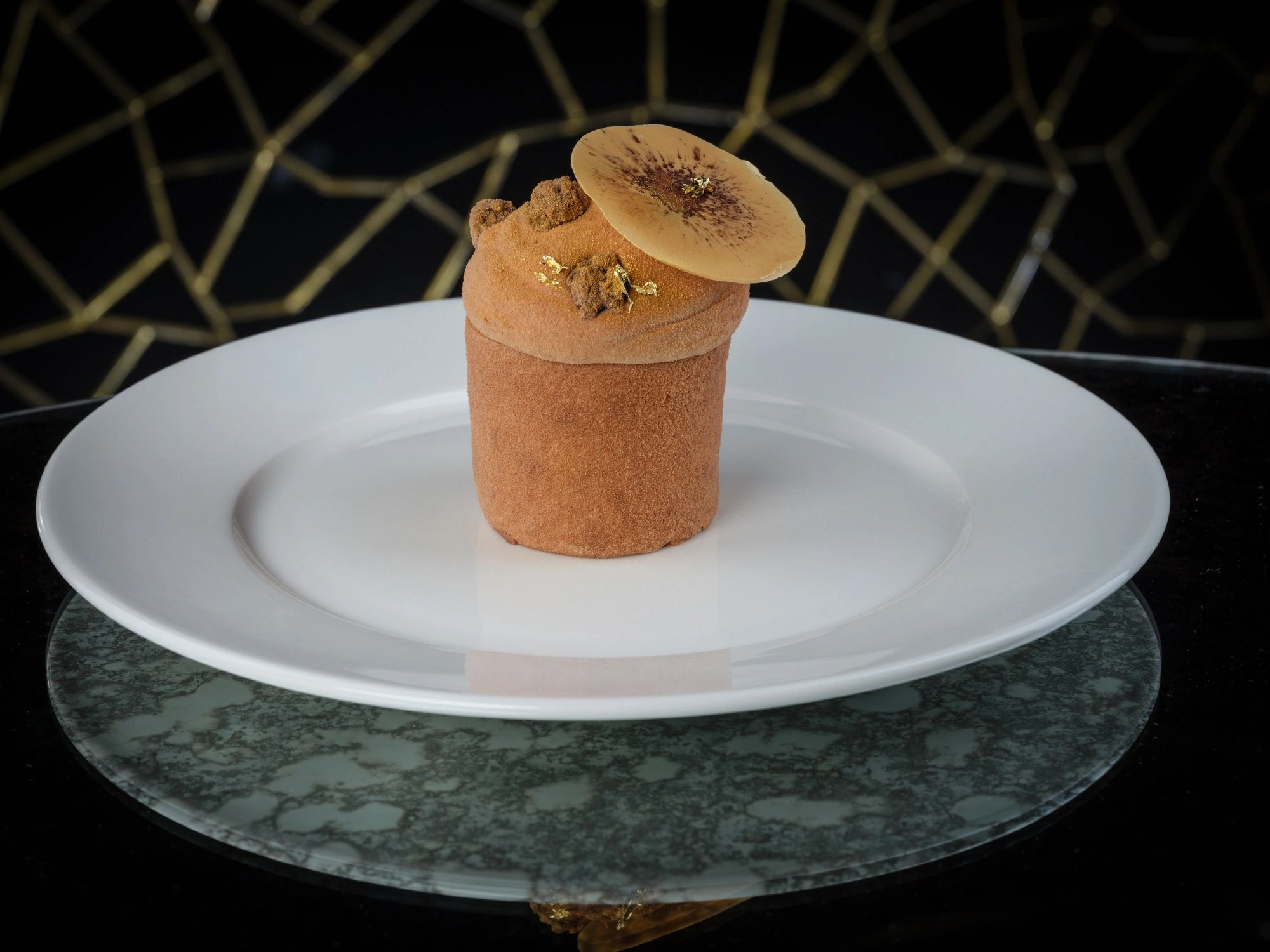Caramel chocolate mousse dessert plated on a white dish